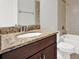 Bathroom featuring a granite countertop, dark cabinets, and a tub and shower combination at 20106 Bending Creek Pl, Tampa, FL 33647