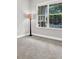 Bedroom featuring carpet, a lamp, and natural light from a large window with a view at 20106 Bending Creek Pl, Tampa, FL 33647
