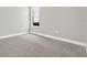 Bright bedroom with neutral carpet and trim, featuring a window offering natural light at 20106 Bending Creek Pl, Tampa, FL 33647