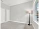 Bedroom featuring carpet, closets, a lamp, and natural light from a large window with a view at 20106 Bending Creek Pl, Tampa, FL 33647