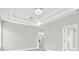 Large bedroom with tray ceilings, neutral walls and adjacent doors at 20106 Bending Creek Pl, Tampa, FL 33647