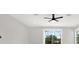 Bright bedroom with modern ceiling fan, recessed lighting, and a view of the backyard and lake at 20106 Bending Creek Pl, Tampa, FL 33647