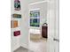 Walk-in closet leading to a bathroom with soaking tub and a tranquil outdoor view at 20106 Bending Creek Pl, Tampa, FL 33647