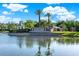 Grand Hampton entrance features lush landscaping, a scenic lake, and elegant signage at 20106 Bending Creek Pl, Tampa, FL 33647