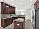 Well-appointed kitchen featuring granite countertops, dark cabinetry, and stainless steel appliances at 20106 Bending Creek Pl, Tampa, FL 33647