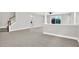 Bright, open living room with staircase, carpet, and large glass doors to a patio view at 20106 Bending Creek Pl, Tampa, FL 33647