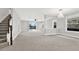 Expansive living room with a staircase, an open floor plan, carpeted floors and abundant natural light at 20106 Bending Creek Pl, Tampa, FL 33647