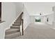 Spacious living room boasts plush carpet and staircase with backyard view through sliding glass doors at 20106 Bending Creek Pl, Tampa, FL 33647
