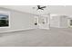 Spacious living room with carpeted floors and an open floor plan concept with access to other areas of the home at 20106 Bending Creek Pl, Tampa, FL 33647