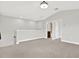 Open loft area with neutral paint, carpet, and views of the entry to the bathroom at 20106 Bending Creek Pl, Tampa, FL 33647