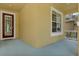 Inviting front porch featuring a blue floor, windows, and a front door at 20106 Bending Creek Pl, Tampa, FL 33647