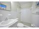 All-white full bathroom with tiled shower and mosaic tile floor at 2073 Denmark St # 9, Clearwater, FL 33763