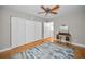 A cozy bedroom is furnished with a vanity and has wood flooring and closet at 2073 Denmark St # 9, Clearwater, FL 33763