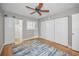 Bright bedroom with wooden floors, ceiling fan, closet, and ensuite bathroom at 2073 Denmark St # 9, Clearwater, FL 33763