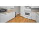 Bright kitchen featuring white cabinets, modern appliances, and wood-look flooring at 2073 Denmark St # 9, Clearwater, FL 33763