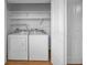 Laundry room with washer, dryer, and shelving at 2073 Denmark St # 9, Clearwater, FL 33763