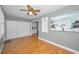 Living room showcasing wood-look floors, closet doors and artwork at 2073 Denmark St # 9, Clearwater, FL 33763