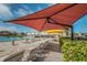 Inviting community pool featuring colorful umbrellas and plenty of lounge chairs for sunbathing at 2073 Denmark St # 9, Clearwater, FL 33763