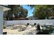 Spacious backyard featuring a white privacy fence, lounge furniture, and ample space for outdoor activities at 2219 Thrace St, Tampa, FL 33605
