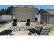 Backyard featuring lounge chairs, a shed, white fence and ample space for relaxation and outdoor activities at 2219 Thrace St, Tampa, FL 33605