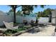 Backyard area featuring a white fence, garden space, and seating, offering a relaxing outdoor retreat at 2219 Thrace St, Tampa, FL 33605