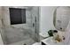 This bathroom features a modern vanity, sleek gold fixtures, and a glass-enclosed shower with marble tile at 2219 Thrace St, Tampa, FL 33605