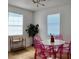 Stylish dining room with pink acrylic chairs and a modern chandelier at 2219 Thrace St, Tampa, FL 33605