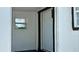 Home entryway featuring a white front door with dark trim and a small side window at 2219 Thrace St, Tampa, FL 33605