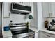 Bright kitchen features quartz countertops, gold hardware, stainless steel appliances, and shaker style cabinets at 2219 Thrace St, Tampa, FL 33605