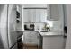 Well-equipped kitchen features white cabinets, quartz countertops, and stainless steel appliances at 2219 Thrace St, Tampa, FL 33605