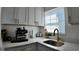 Bright kitchen features quartz countertops, gold hardware, stainless steel appliances, and shaker style cabinets at 2219 Thrace St, Tampa, FL 33605