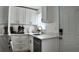 Bright kitchen features quartz countertops, gold hardware, stainless steel appliances, and shaker style cabinets at 2219 Thrace St, Tampa, FL 33605