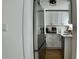 A modern kitchen boasts stainless steel appliances, sleek white cabinets and stunning hardwood floors at 2219 Thrace St, Tampa, FL 33605