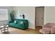 Inviting living room with a green sofa, pink pillows, sleek decor and a comfortable pink chair at 2219 Thrace St, Tampa, FL 33605
