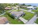 An aerial view shows the property with a large driveway, green lawn, and nearby waterfront access at 22852 Fern Ct, Land O Lakes, FL 34639