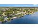 Waterfront homes with docks on a sunny day surrounded by lush greenery and lake views at 22852 Fern Ct, Land O Lakes, FL 34639