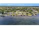 Aerial view of waterfront homes, boat docks, and lush landscaping on a sunny day at 22852 Fern Ct, Land O Lakes, FL 34639