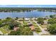 Aerial view of lakeside homes with lush landscaping, showcasing waterfront living and neighborhood charm at 22852 Fern Ct, Land O Lakes, FL 34639