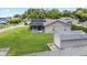 A view of the home's back exterior with solar panels, a screened in porch and a storage shed at 22852 Fern Ct, Land O Lakes, FL 34639