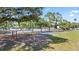 Community basketball court with playground equipment and shaded trees at 22852 Fern Ct, Land O Lakes, FL 34639