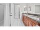 Bathroom featuring double vanity, stone counters, and tiled flooring at 22852 Fern Ct, Land O Lakes, FL 34639