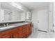Bathroom with double vanity, stone counters, and white tiled flooring at 22852 Fern Ct, Land O Lakes, FL 34639