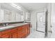 Bathroom with double vanity, stone counters, and white tiled flooring at 22852 Fern Ct, Land O Lakes, FL 34639