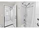 Bathroom featuring tiled shower and tub and a door to the exterior at 22852 Fern Ct, Land O Lakes, FL 34639