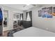 Cozy bedroom featuring a mirrored closet, gray dresser, and modern artwork at 22852 Fern Ct, Land O Lakes, FL 34639