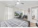 Bedroom featuring a desk area with computer setup, ceiling fan and plaid comforter at 22852 Fern Ct, Land O Lakes, FL 34639