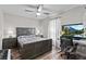 Comfortable bedroom with ceiling fan, two bedside tables and a full size bed at 22852 Fern Ct, Land O Lakes, FL 34639