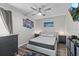 Modern bedroom with neutral tones, hardwood floors, and decorative wall art at 22852 Fern Ct, Land O Lakes, FL 34639