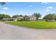 Charming single-story home with well-manicured lawn, landscaping, and neutral exterior at 22852 Fern Ct, Land O Lakes, FL 34639