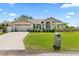 Charming single-story home featuring a two-car garage, manicured lawn, and lovely landscaping at 22852 Fern Ct, Land O Lakes, FL 34639